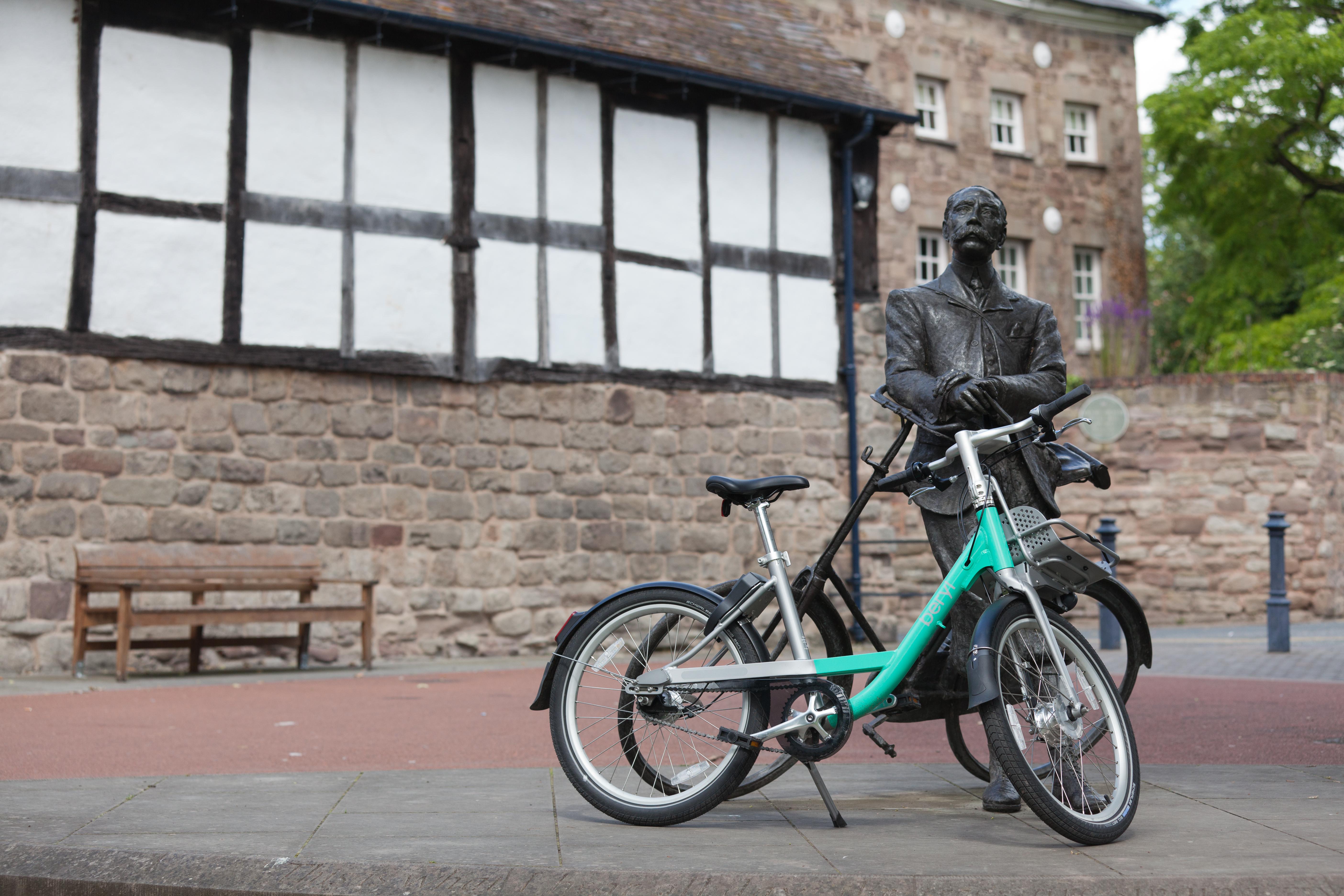 Beryl Bike leaning against statue of Elgar in Cathedral Close