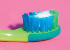 Image of toothbrush with smear of toothpaste suitable for child under 3 years