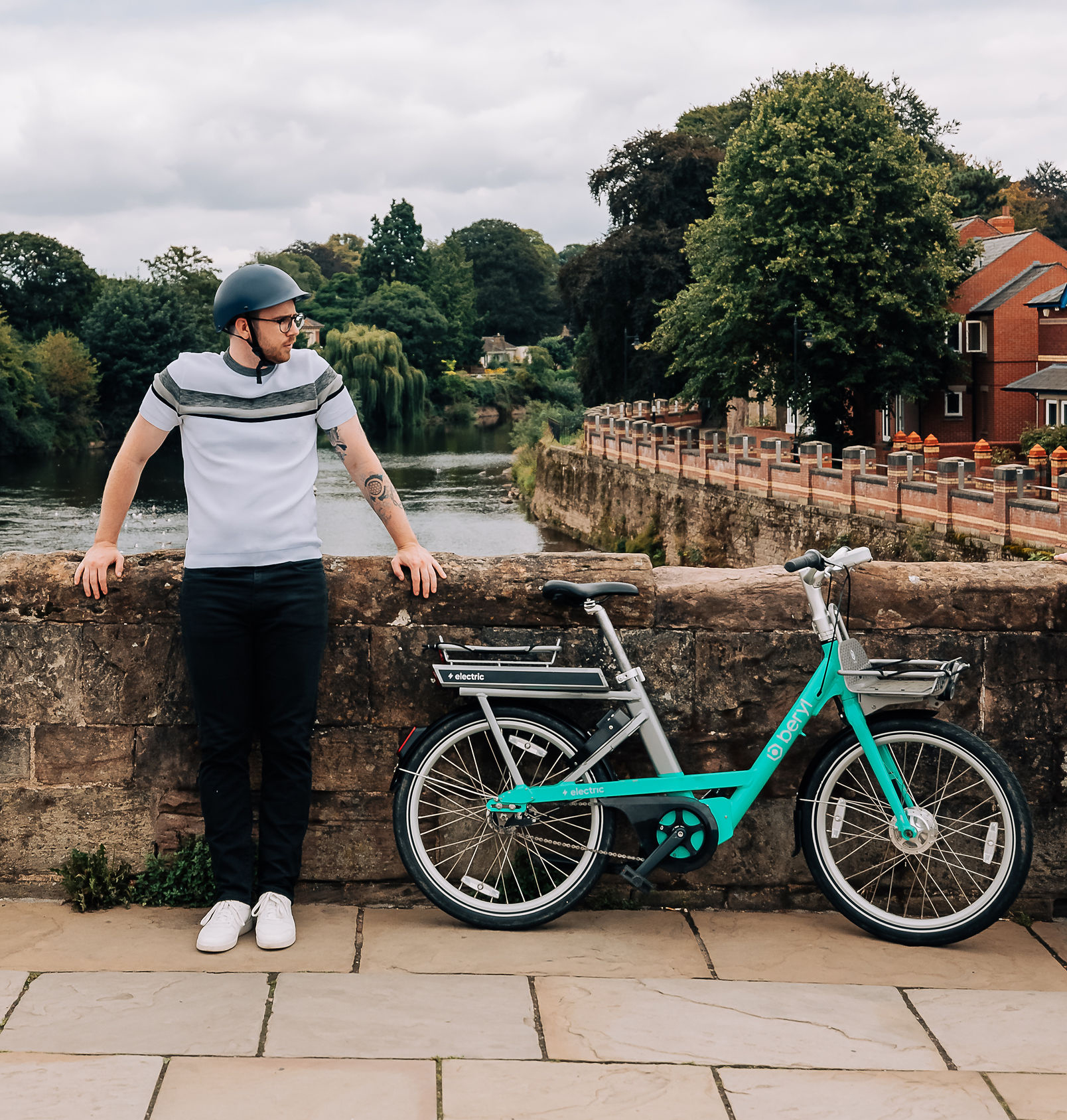 Man standing on bridge with Beryl e-bike