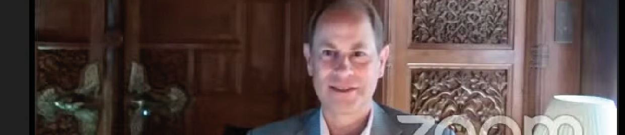 Screenshot of HRH Prince Edward on Zoom smiling and waving