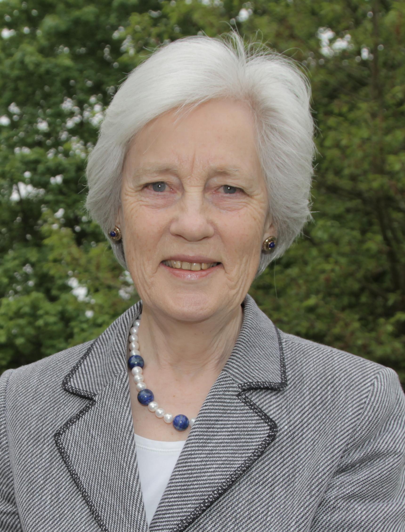 Hm lord lieutenant the dowager countess of darnley cvo smiling in a grey suit with trees in the background