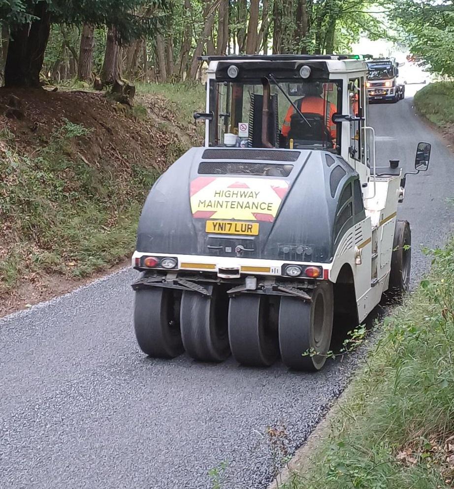A roller flattening chippings on the road