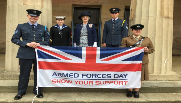Lord Lieutenant and Lord Lieutenant's Cadets holding an Armed Forces Day flag