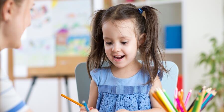 Girl drawing with colour pencils