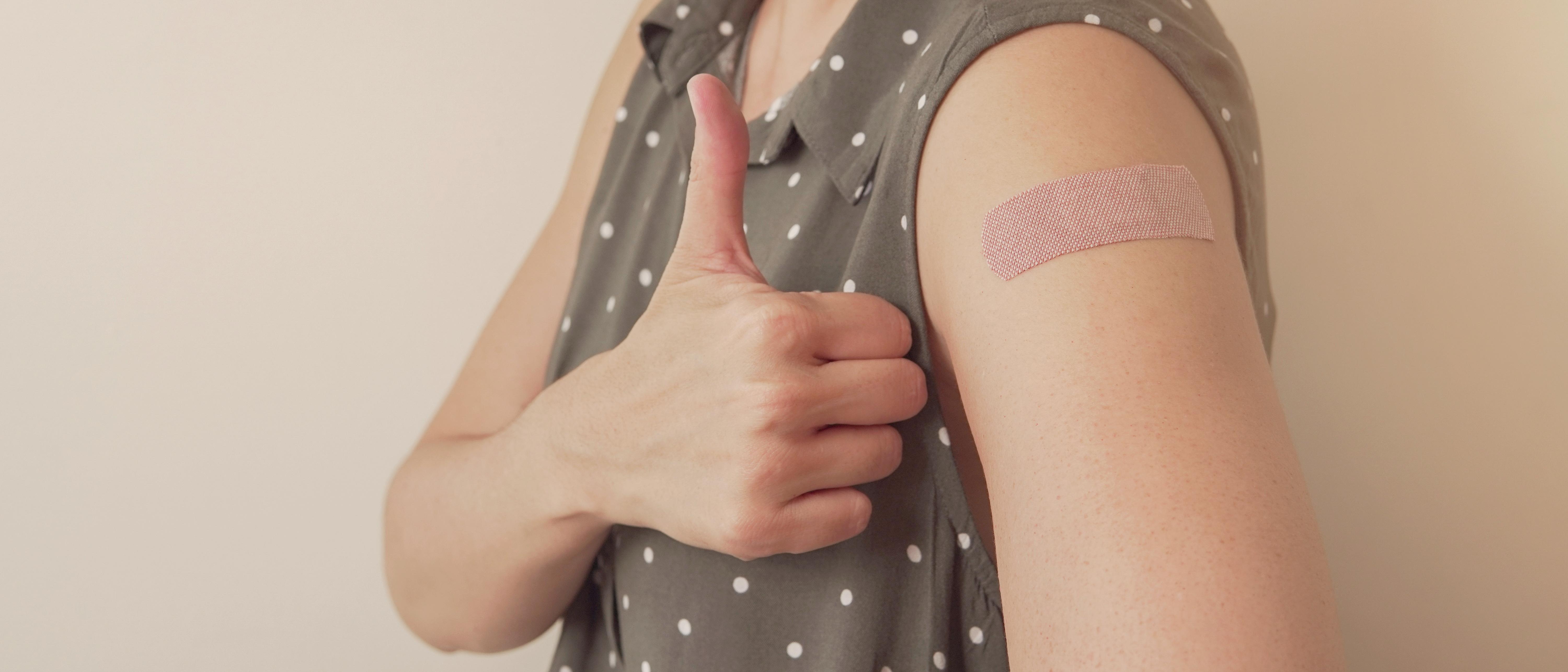 women giving thumbs up after being vaccinated