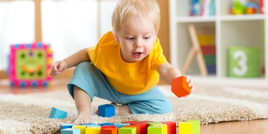 Toddler playing with wooden blocks