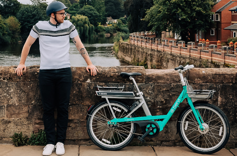 Man standing on bridge with Beryl e-bike