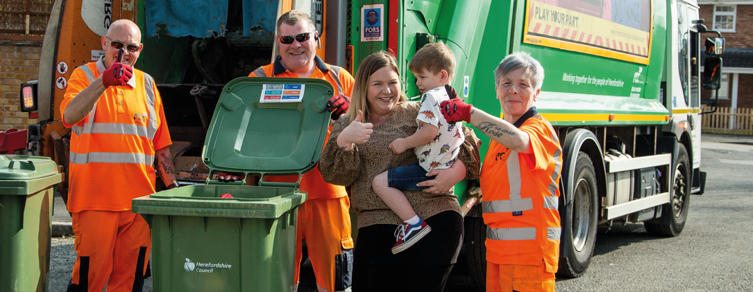 Bin collection crew seen collecting green recycling bins in Herefordshire