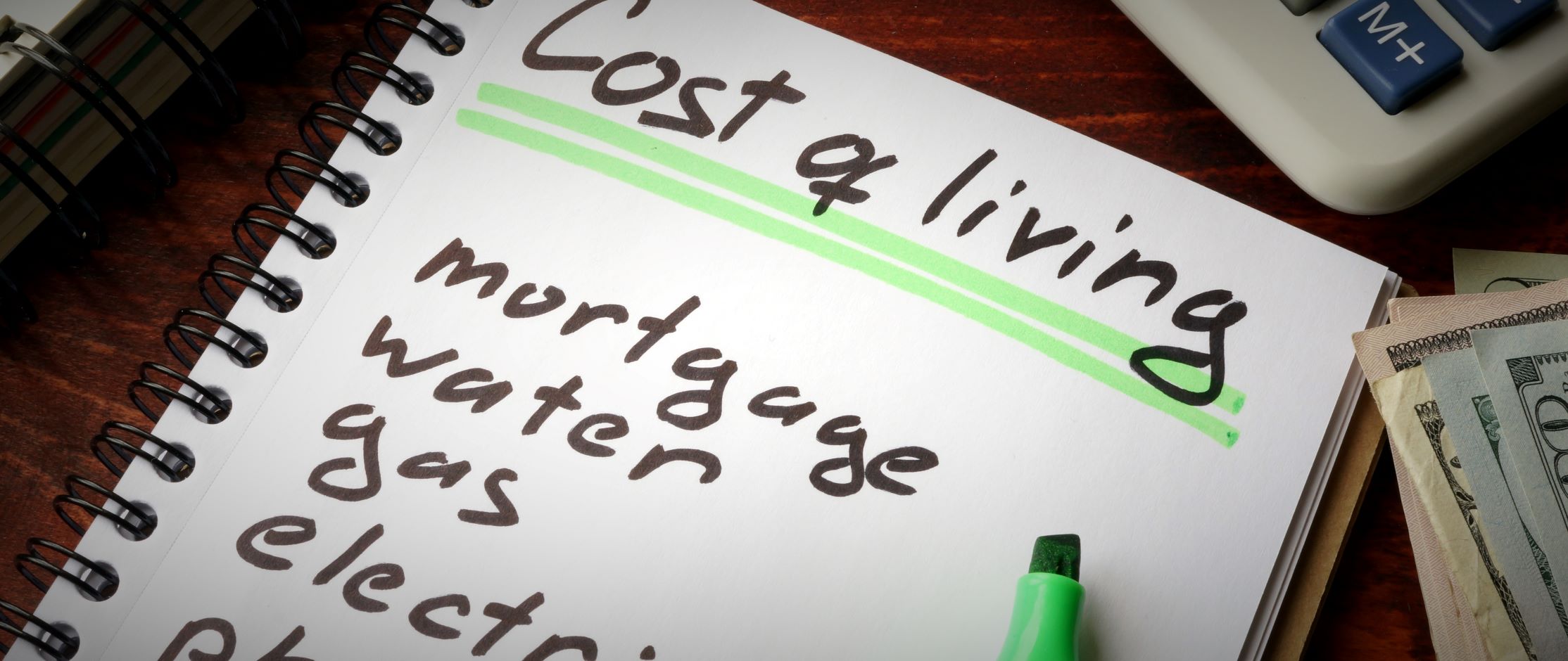 Notepad with list of payments to be made, including mortgage and phone bills