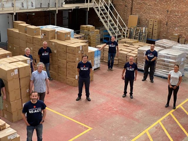 Volunteers in distribution centre with boxes of PPE