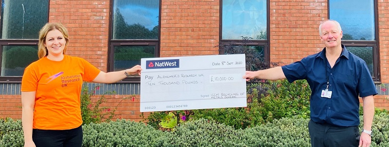 People holding large charity cheque