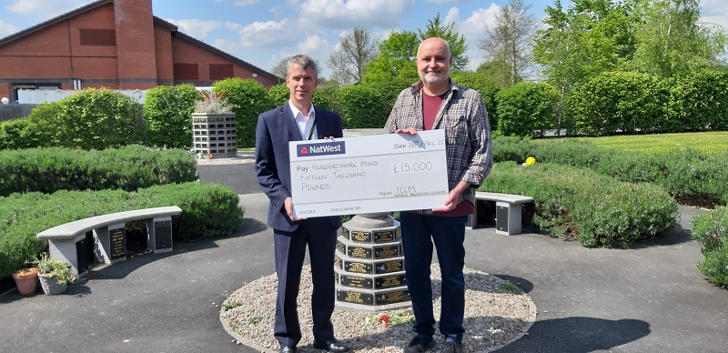 John Gibbon, Herefordshire Council Direct Services Manager, presents cheque to David Harding, Support & Development Manager, Herefordshire Mind.