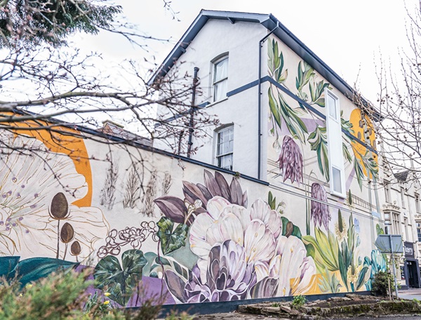 Emmeline North's mural titled 'Our Wild Heart' at Bastion Mews featuring plants from floodplain meadows