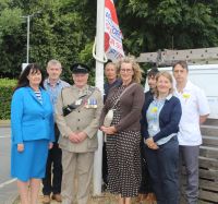 Group at flag raising ceremony, 23 June 2025, to mark start of Armed Forces Week
