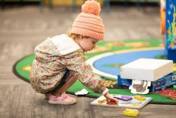 Child playing with wooden jigsaw puzzle
