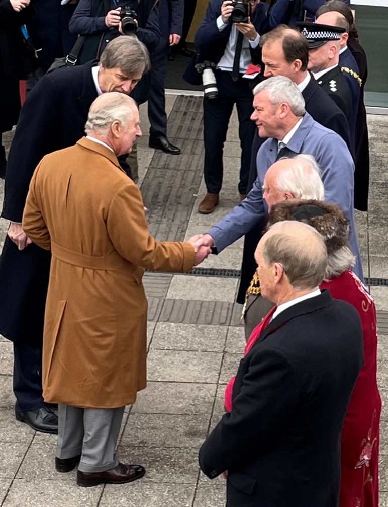 King charles shaking hands with paul walker