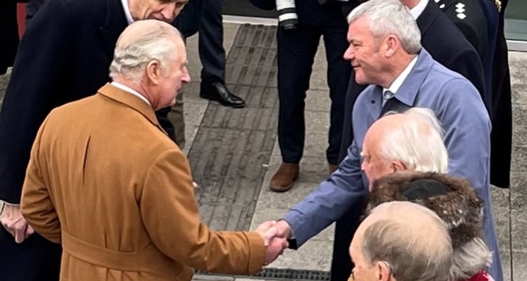 King charles shaking hands with paul walker