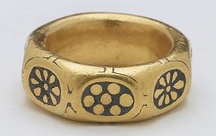A unique gold octagonal finger ring dated to the 9th century with black niello rosette and flower motifs on each of the eight facets. It is decorated with in the Anglo Saxon 'Trewhiddle' style.