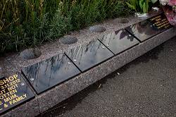 Triple kerb memorial with granite plaque