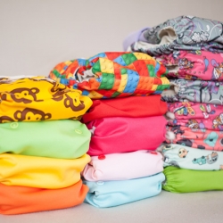 Stack of colourful reusable cloth nappies