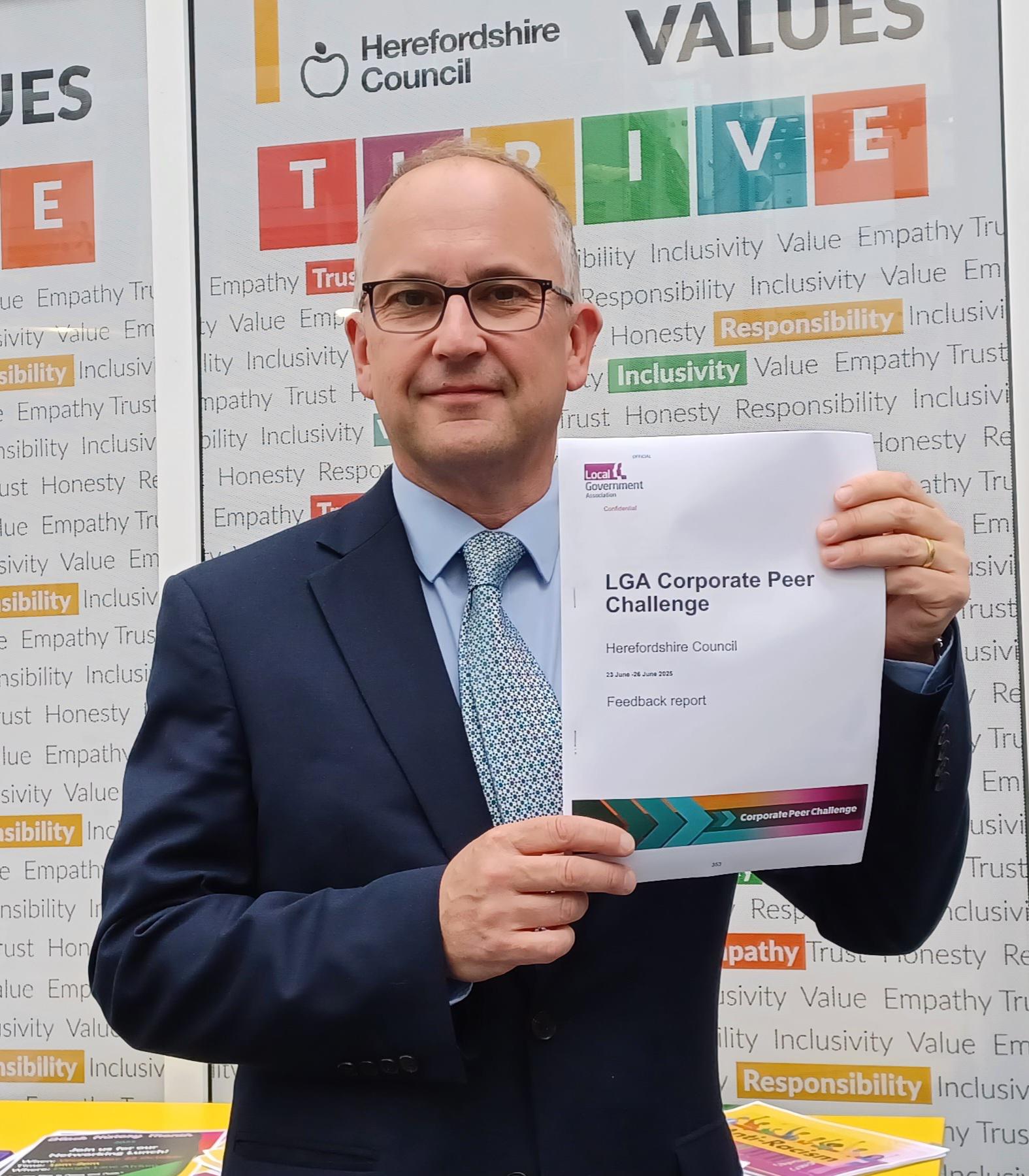 Herefordshire Council Leader, Cllr Jonathan Lester, holding Corporate Peer Challenge Certificate